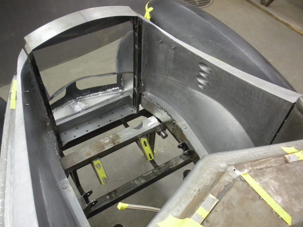 Metal car body under construction.
