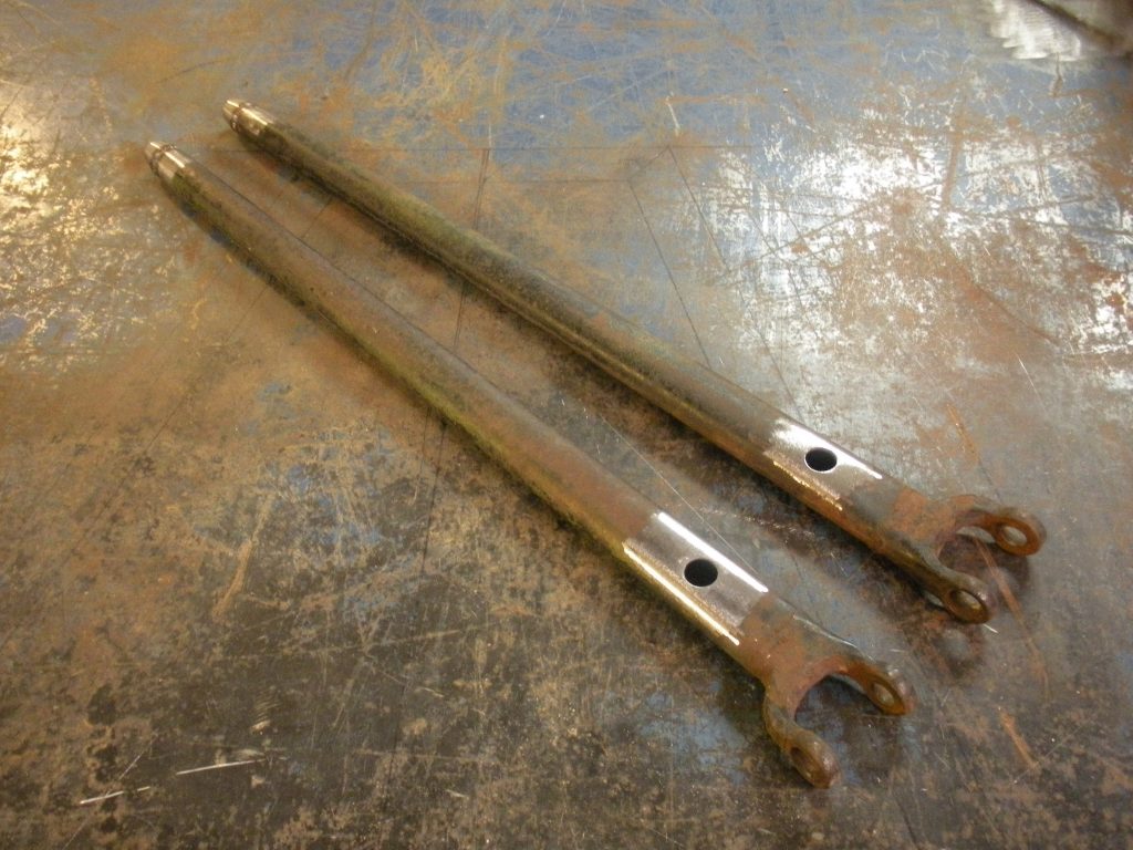Two wrenches are laying on the floor.