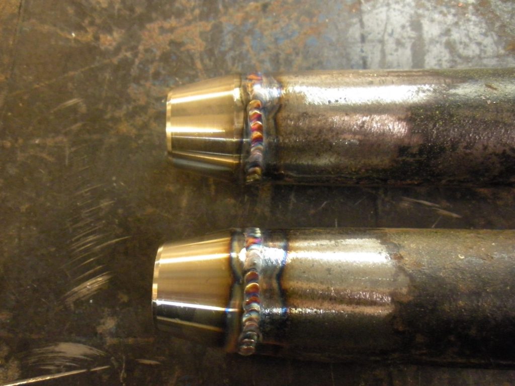 Two bullet casings are shown with a metal ring around them.