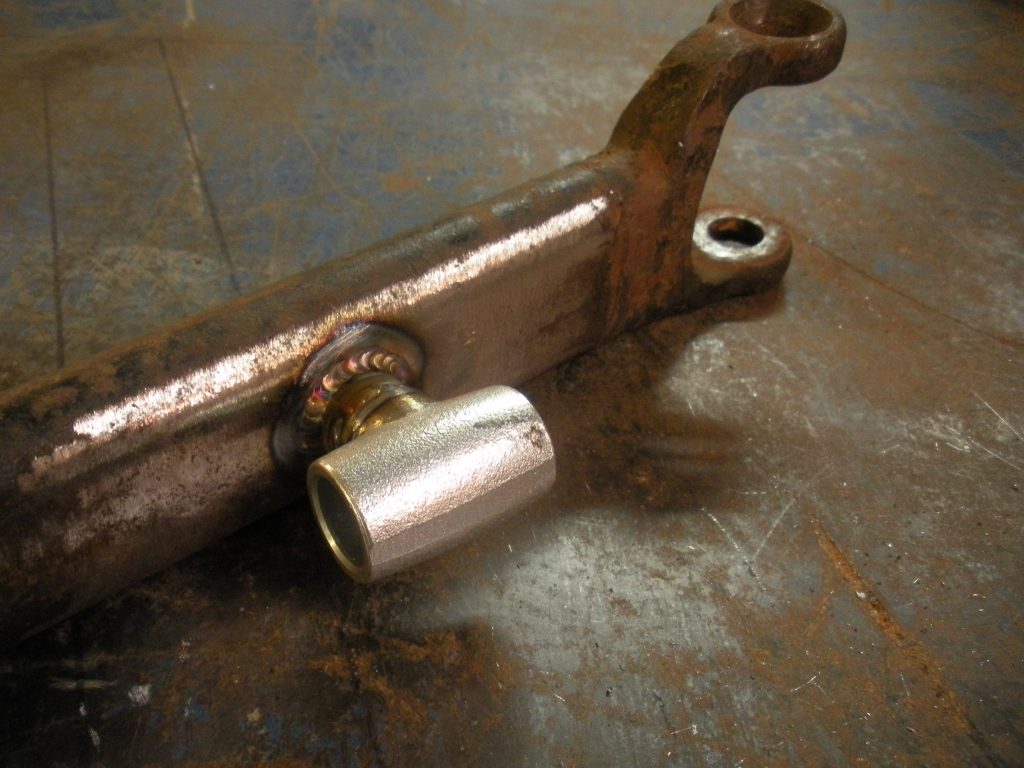 A metal pipe sitting on top of a floor.