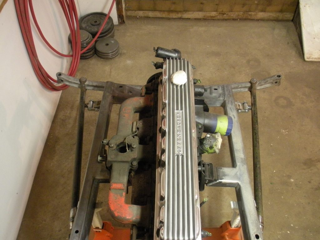 A car engine sitting on top of the floor.