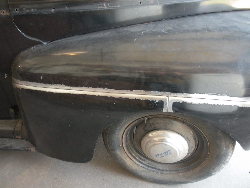 Black classic car fender with weld.