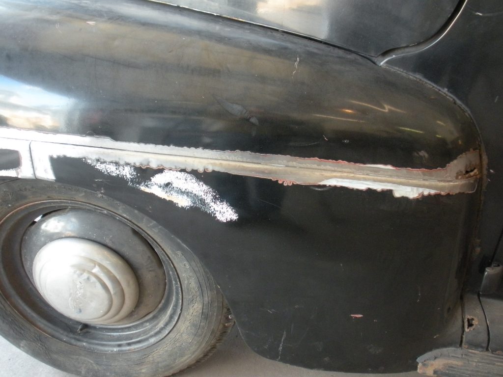 Black vintage car fender repair.