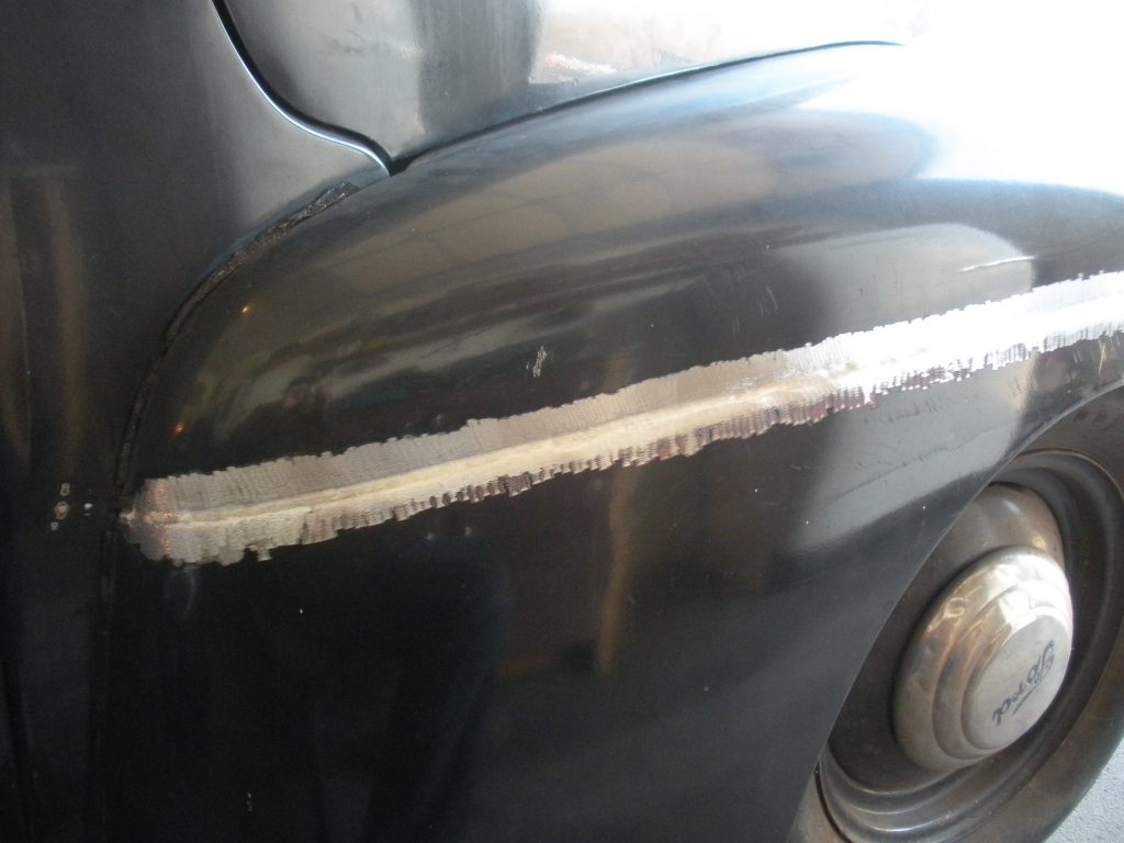 Here's an alt tag for the image: Welded car fender repair.