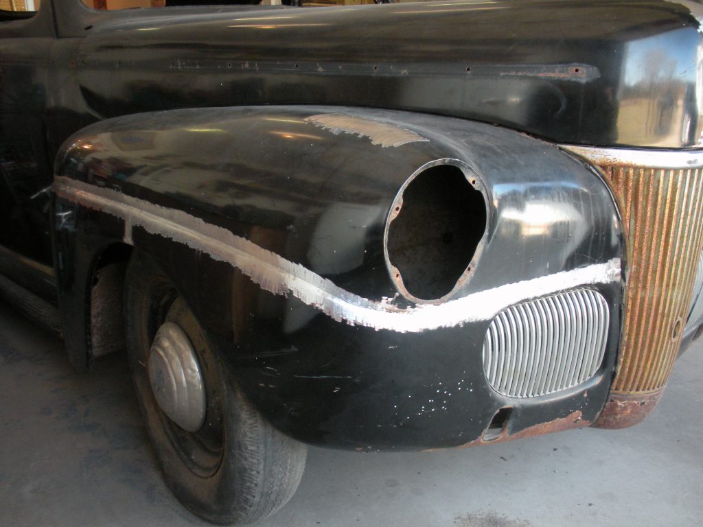 Black classic car fender repair.