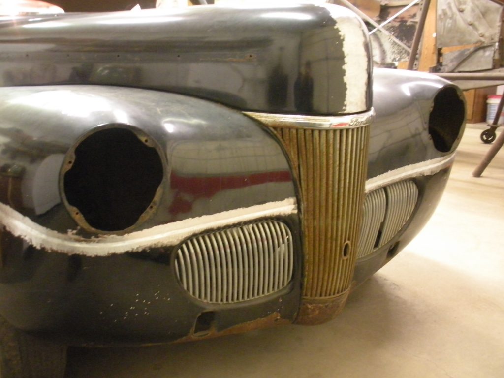 Here's an alt tag for the image: Rusty Ford car front end restoration.
