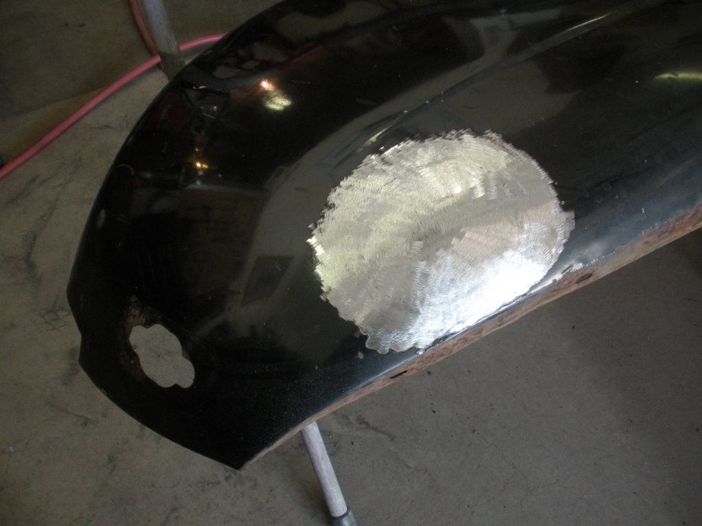 Car body panel with metal patch.