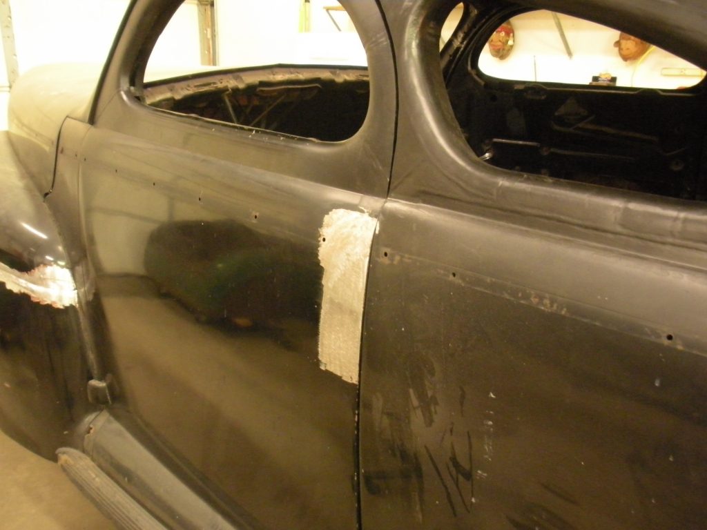 Classic car body panel repair in progress.