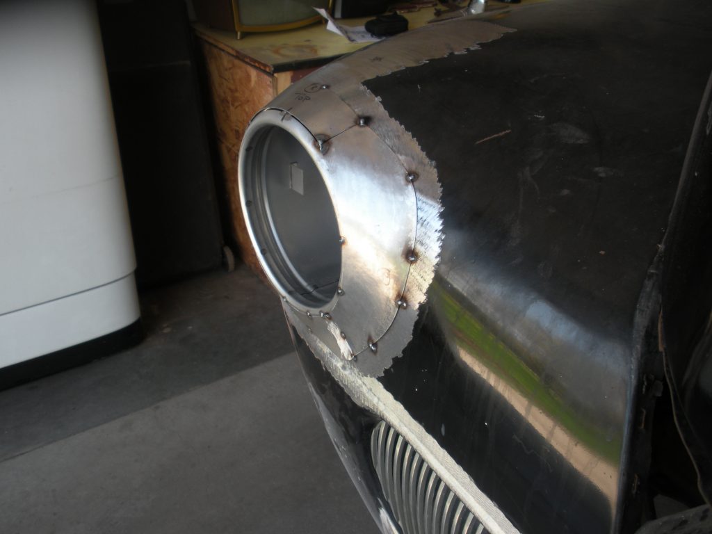 Car headlight fender metal repair.