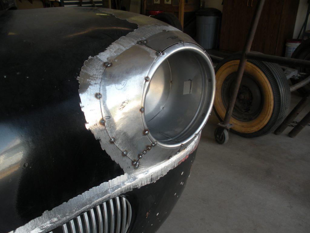 Custom car headlight metalwork in progress.