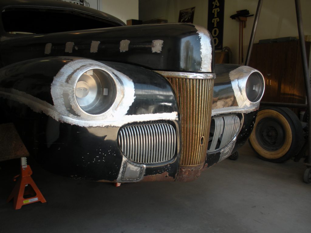 Black classic car under restoration.