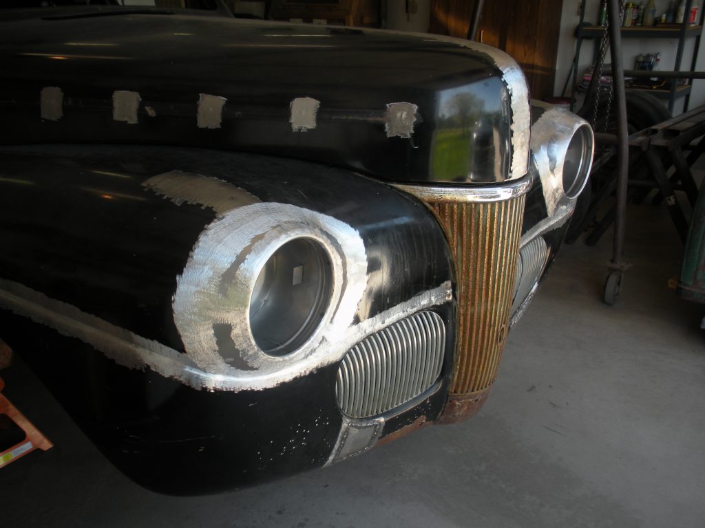 Black classic car under repair.