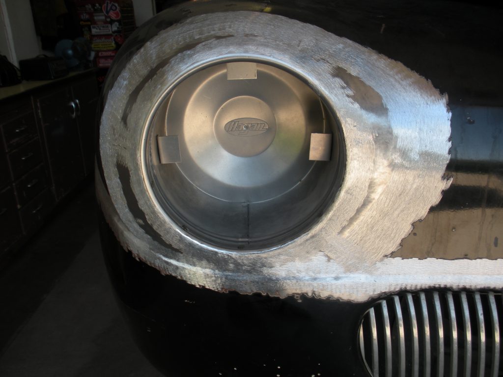 Here's an alt tag for the image: Car headlight restoration in progress.