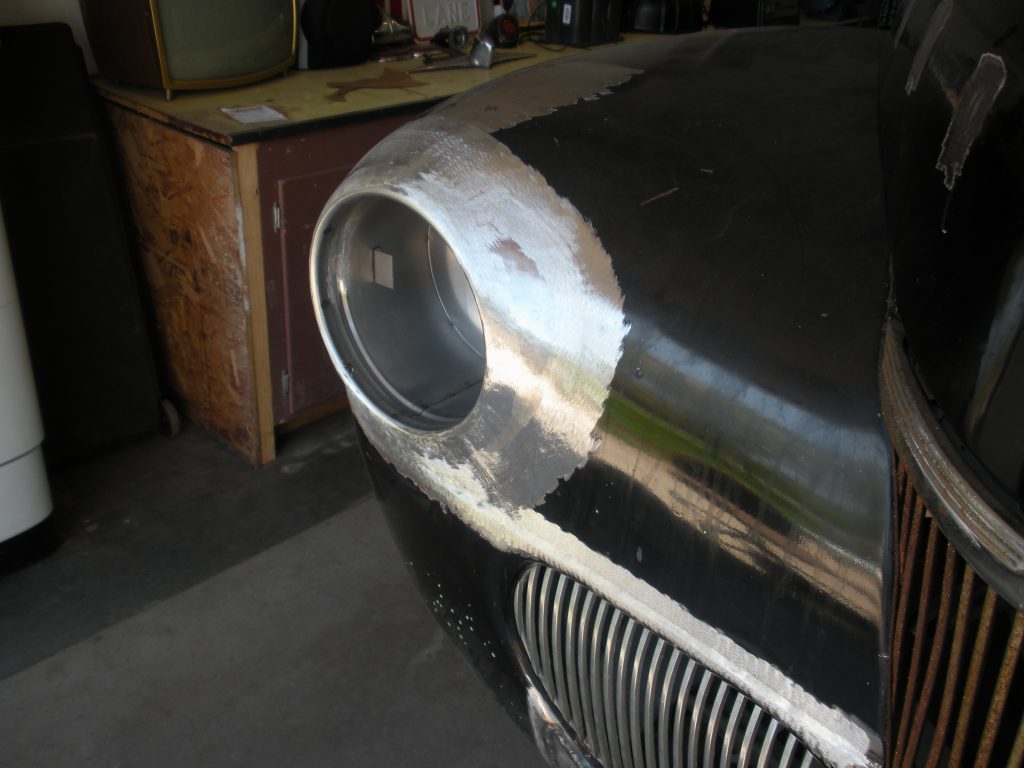 Black car fender, bodywork in progress.
