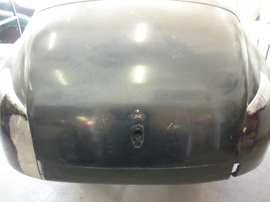 Black classic car trunk, bodywork in progress.