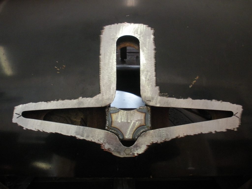 Welded metal part with cutout.