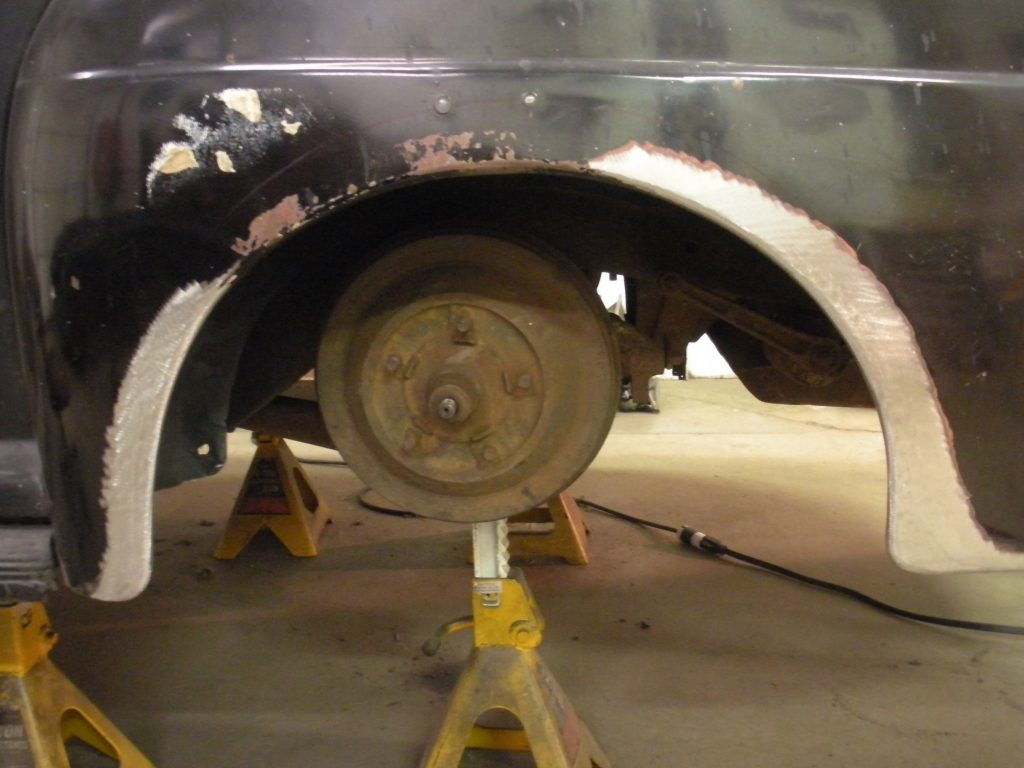 Car wheel well repair in progress.