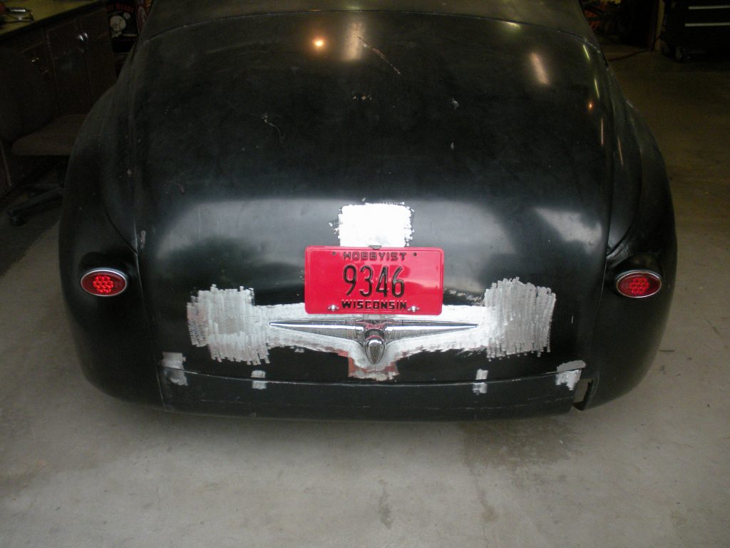 Black car's rear with Wisconsin plates.