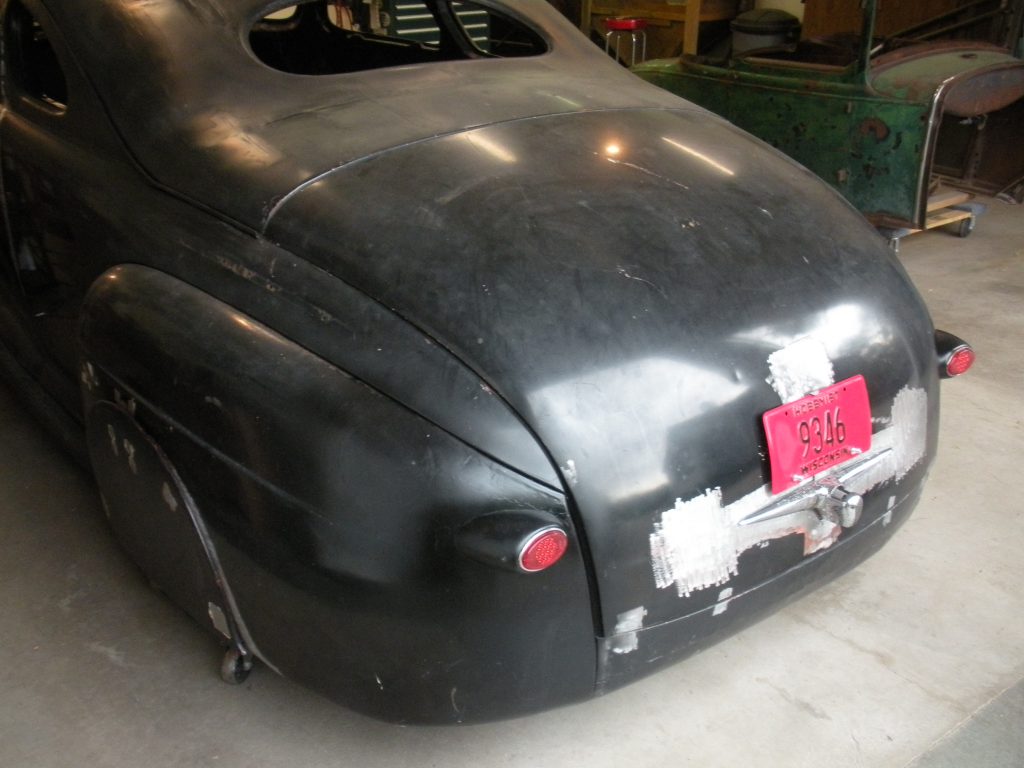 Black classic car rear, Wisconsin plates.