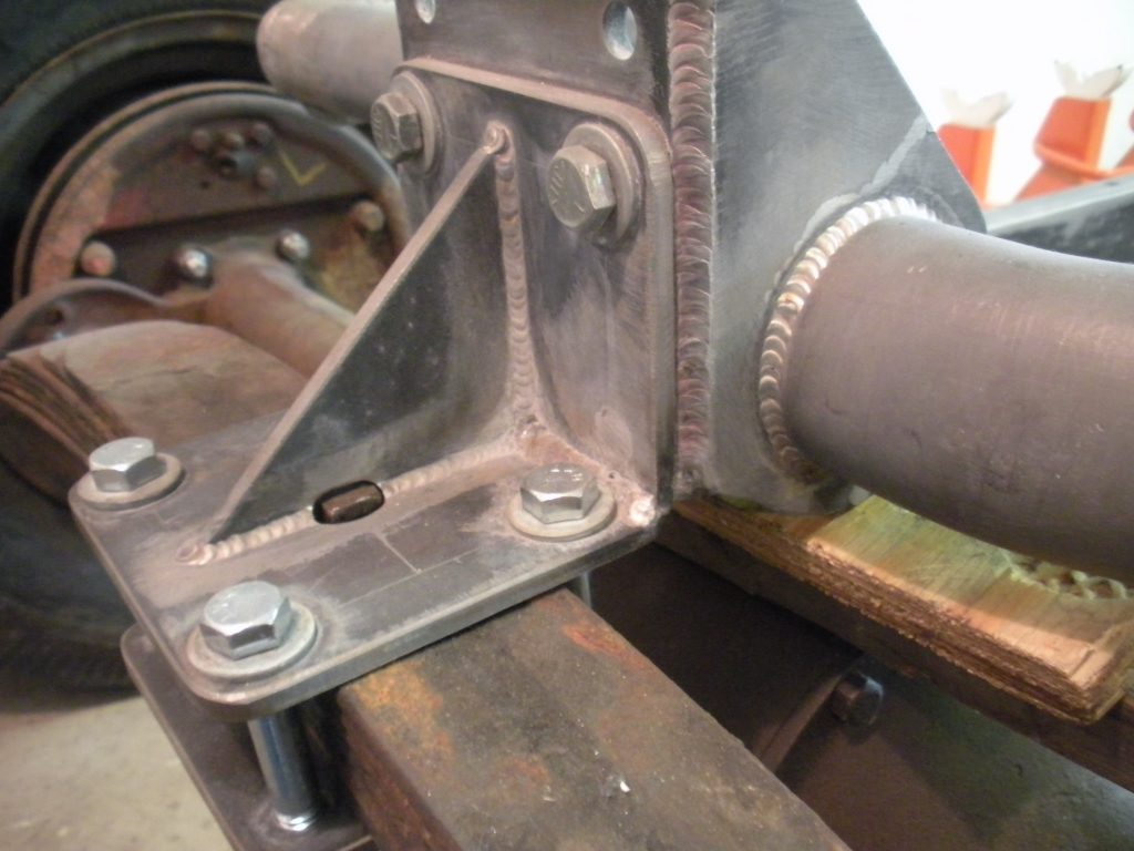 A metal piece of machinery sitting on top of a wooden table.