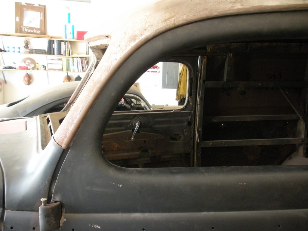 A car that is sitting in the dirt.