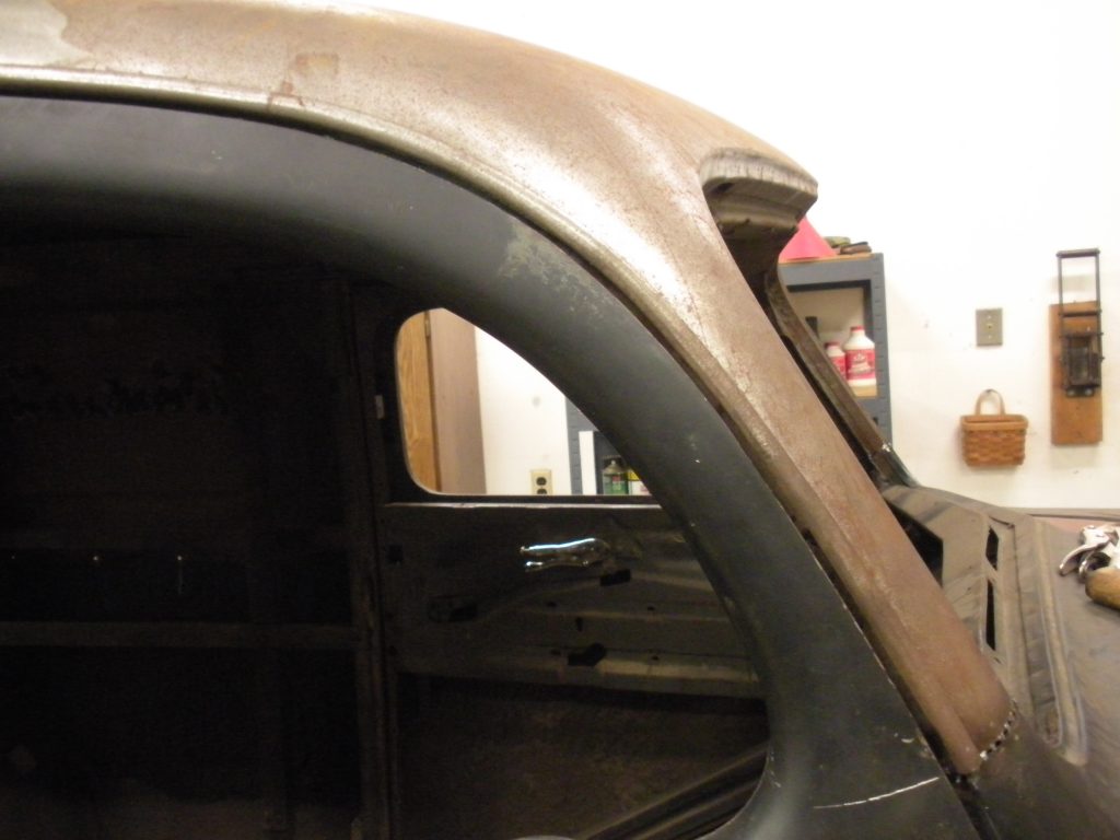 A close up of the side of an old car.