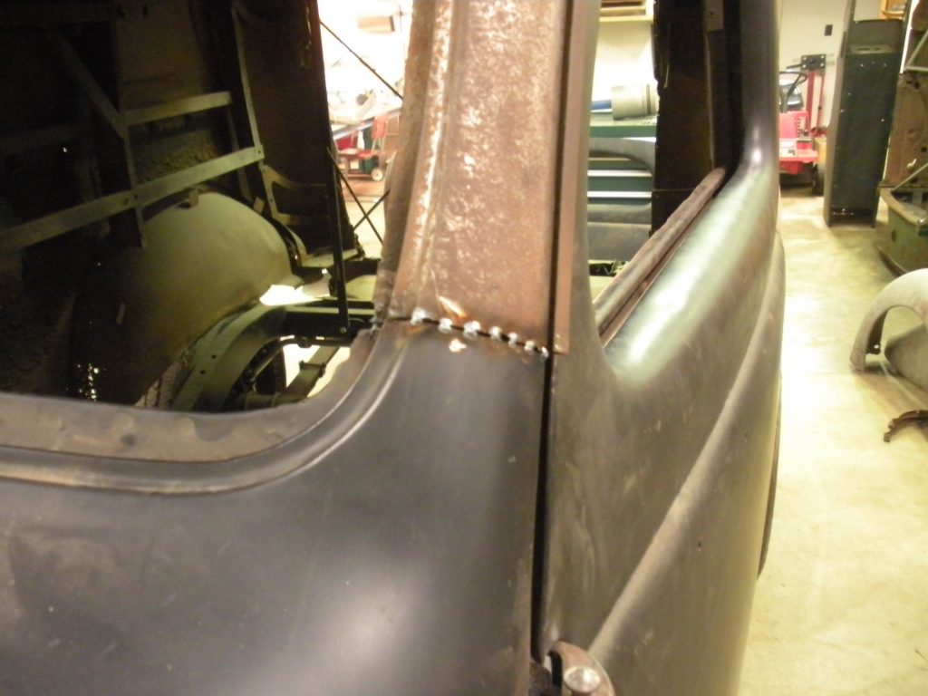A close up of the side of an old car.