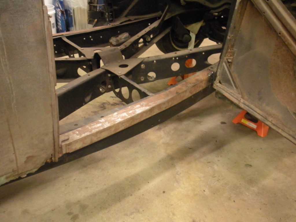 A metal frame with some parts missing in the floor.