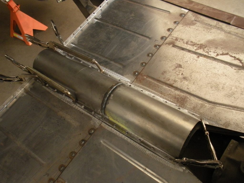 A metal pipe sitting on top of a floor.