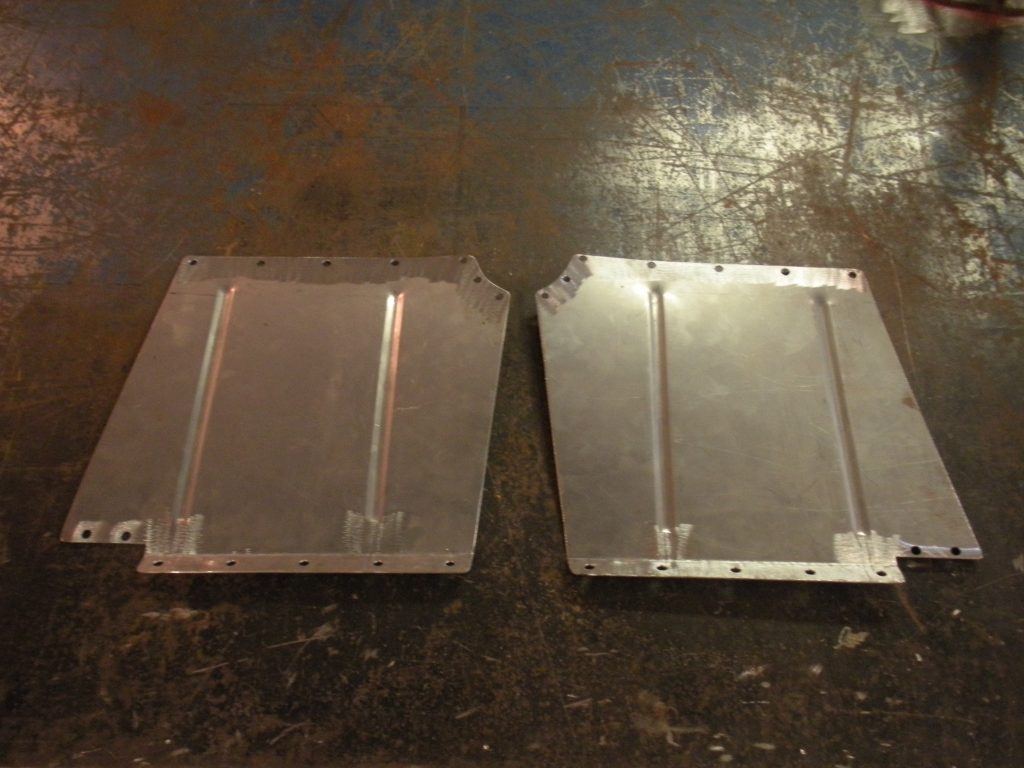 A pair of aluminum panels on the floor.