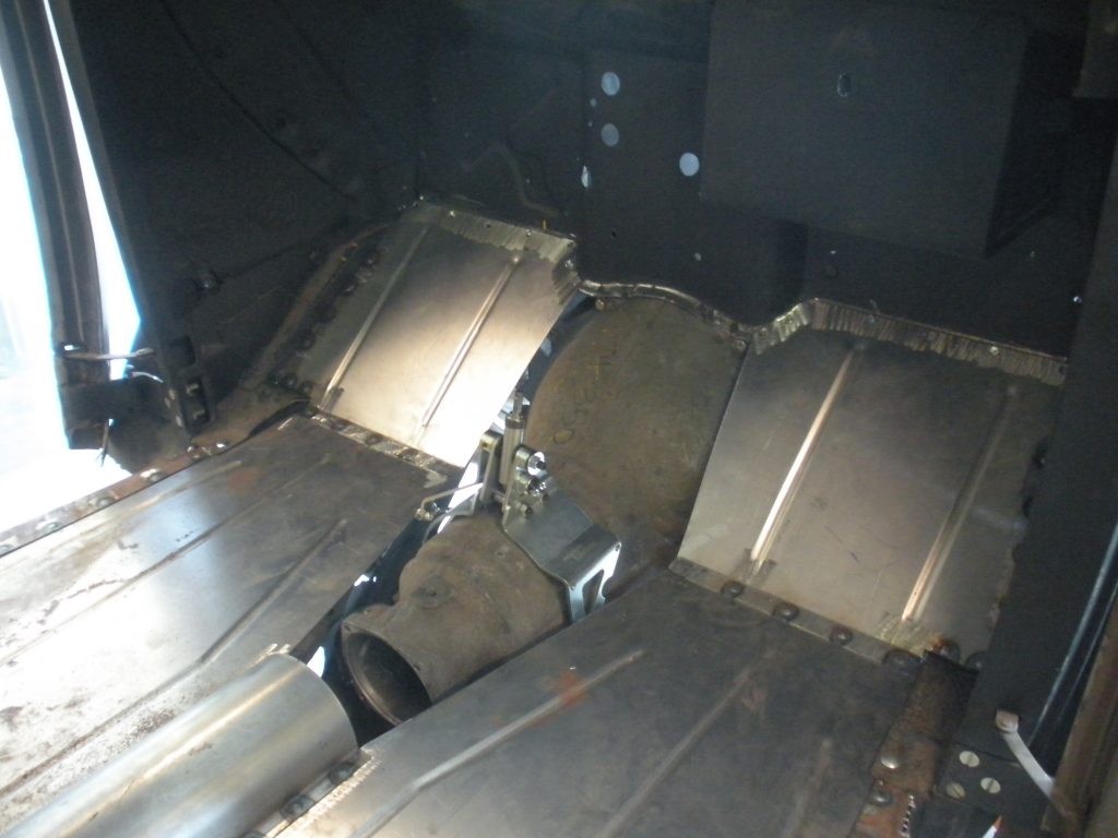 A metal piece of machinery is shown in the dark.