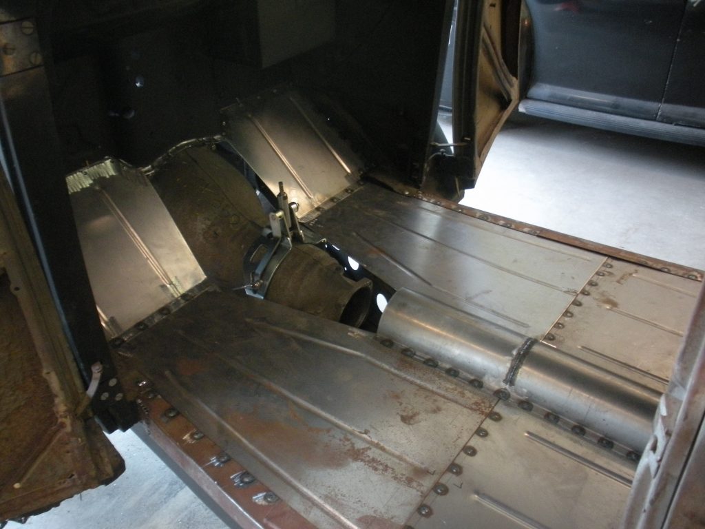 A metal piece of art is shown in the middle of a room.