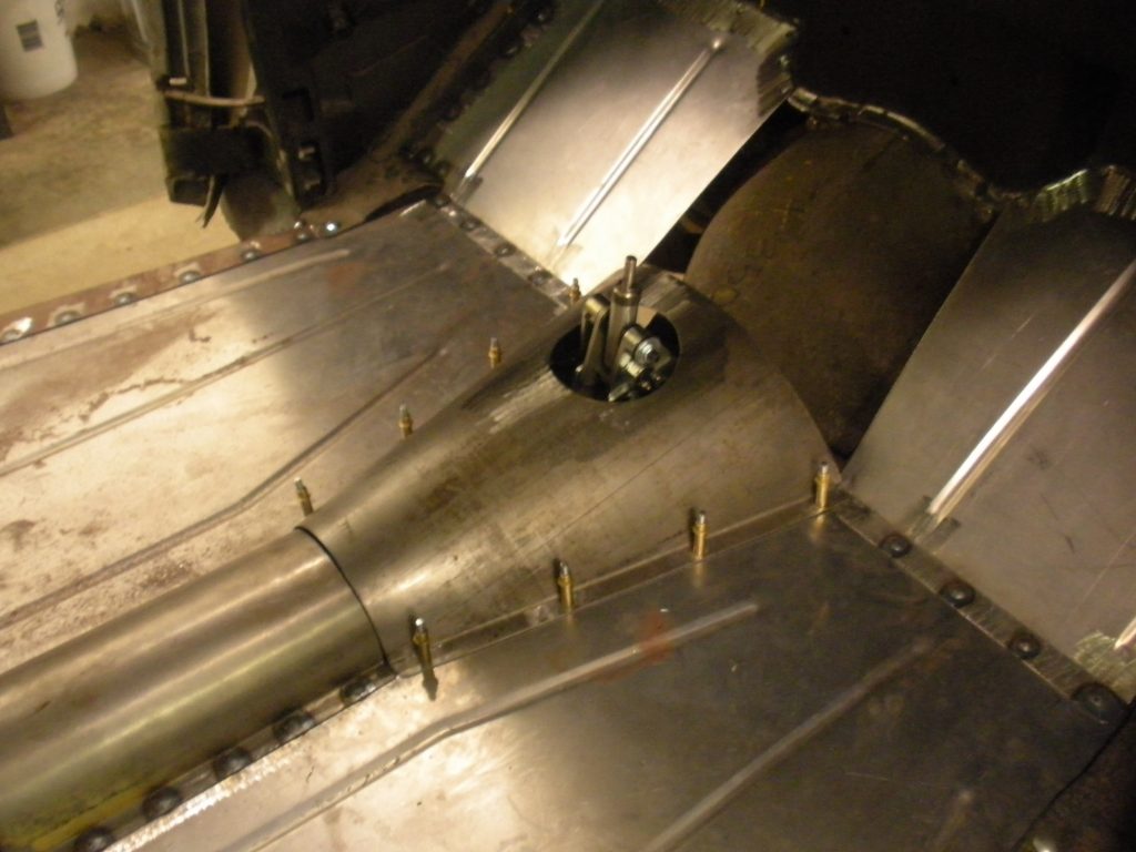 A metal pipe with holes in it is shown.
