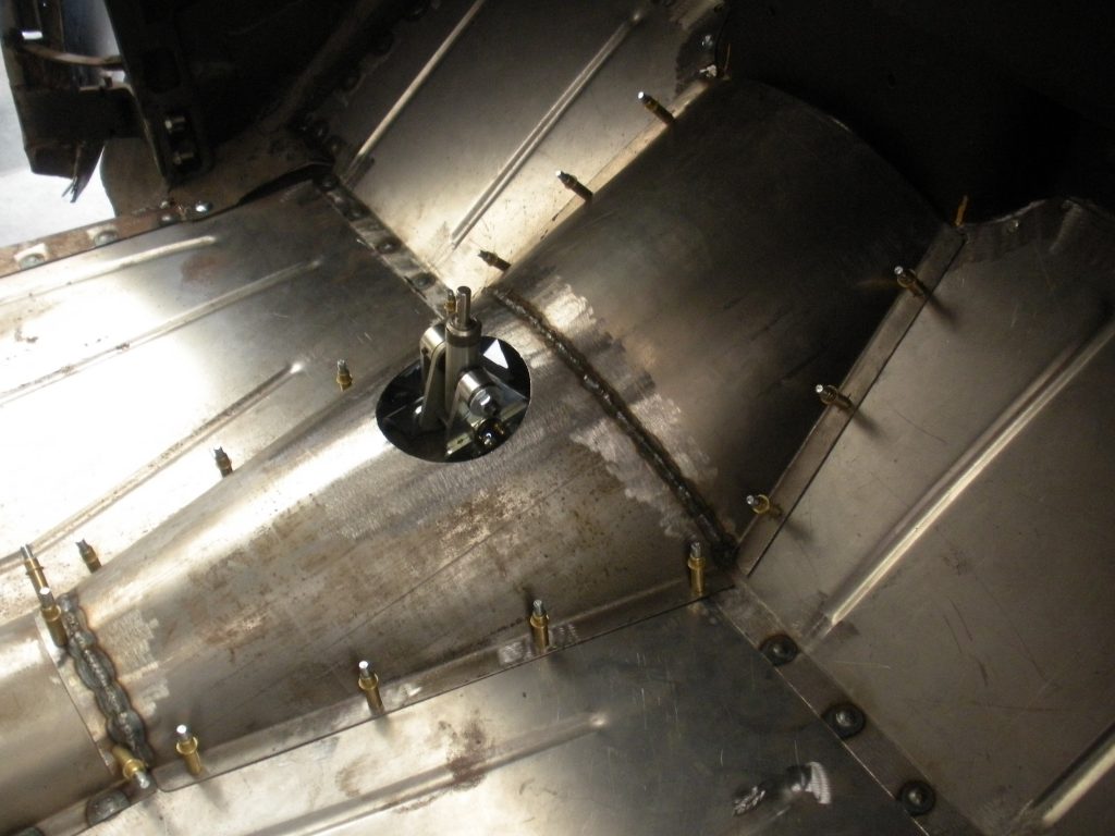 A large metal tank with some holes in it