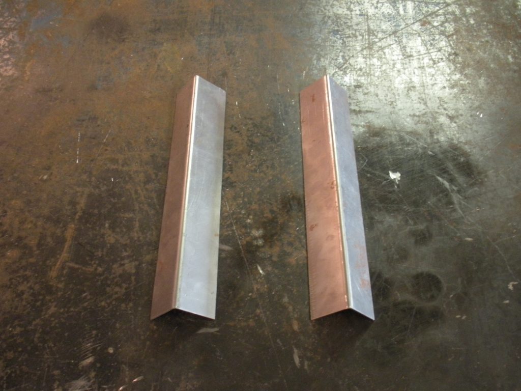 Two pieces of metal are sitting on a table.