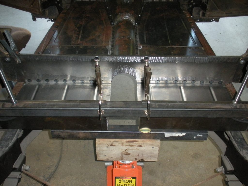 A metal frame with some parts missing and a red object