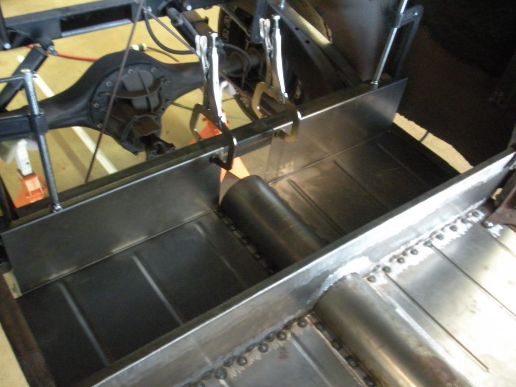 A machine is cutting metal bars with an electric saw.