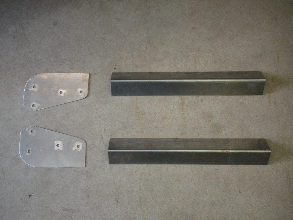 A pair of metal bars and two other parts.
