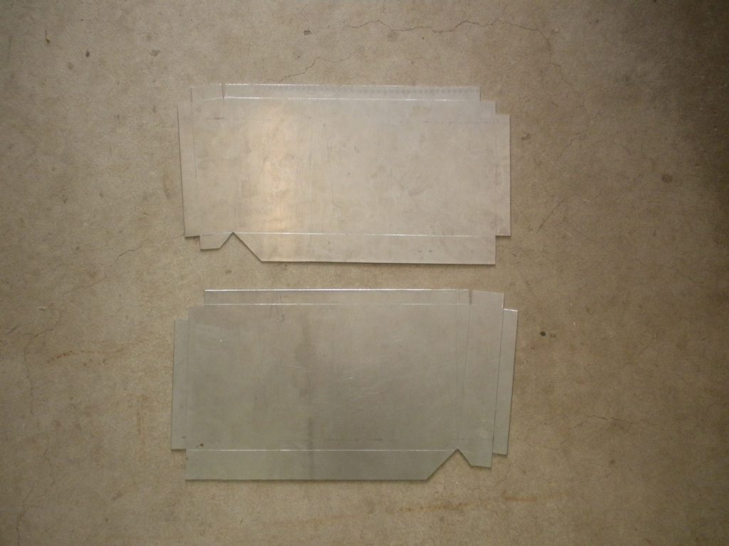 A pair of plastic sheets that are on the floor.