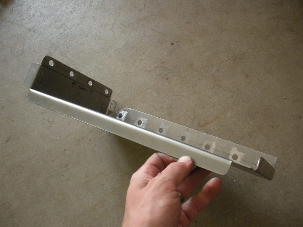 A hand holding the side of a metal bar.