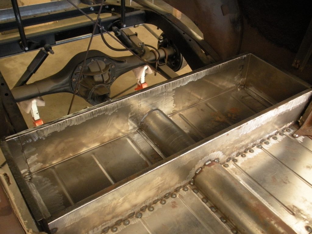 A metal tank sitting on top of a floor.