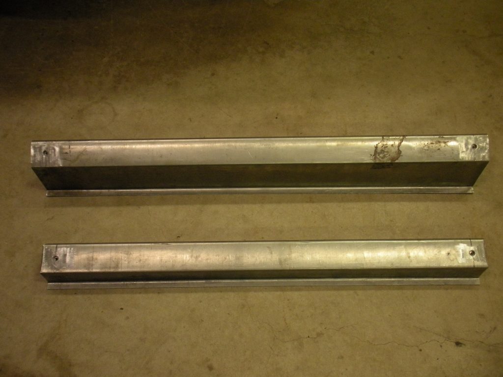 Two metal bars sitting on top of a floor.