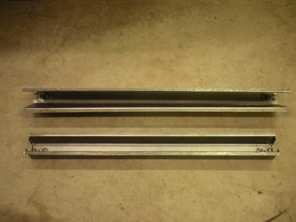 Two metal bars are sitting on the floor.