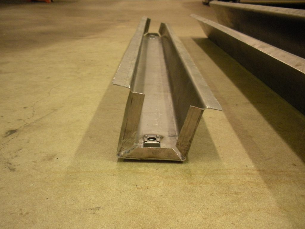 A metal bench sitting on top of a concrete floor.