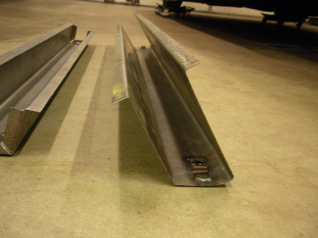 A metal piece of construction is laying on the floor.