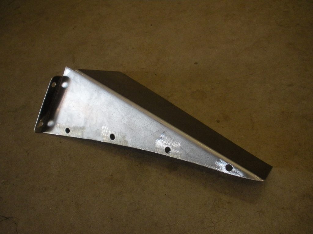 A metal piece of construction is laying on the floor.