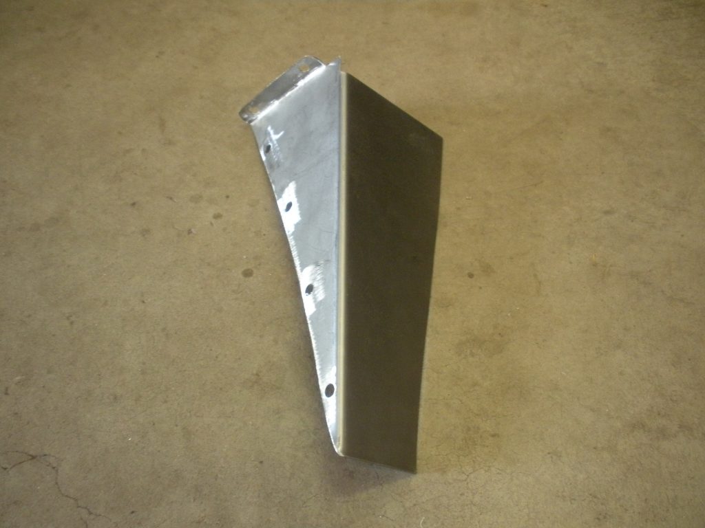 A metal corner piece sitting on top of the floor.