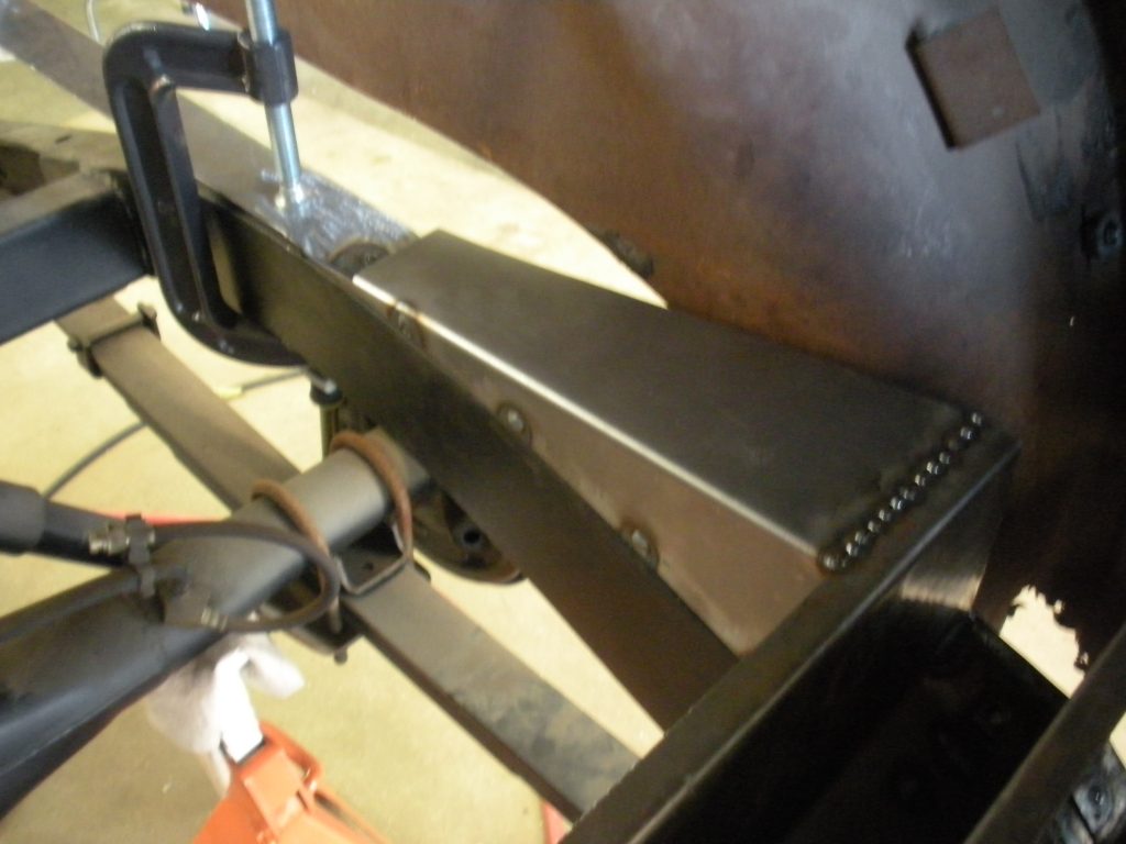 A metal piece of work is being worked on.