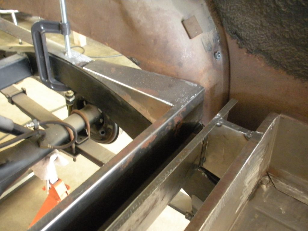 A metal piece of machinery is being worked on.