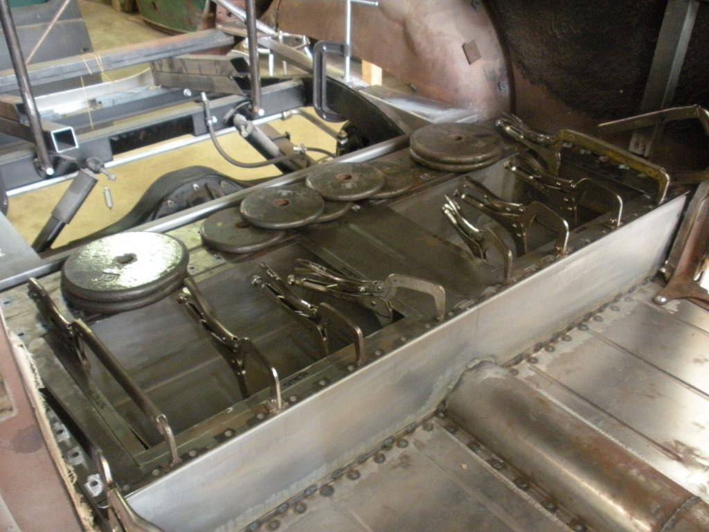 A person is working on an industrial oven.
